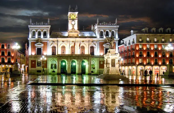 Night view of landmark Plaza Mayor and town hall building in Valladolid, Spain,  in a rainy night.