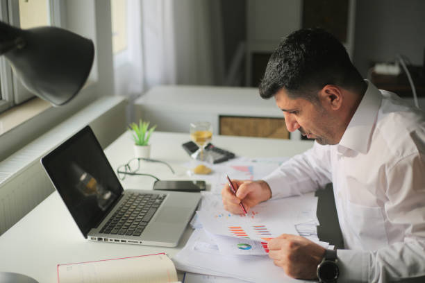 istock Focused serious businessman working at home. 1293782222