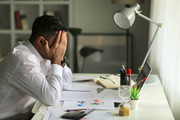 istock Thoughtful doubtful businessman in tension thinking make difficult decision at homeoffice. 1293782292
