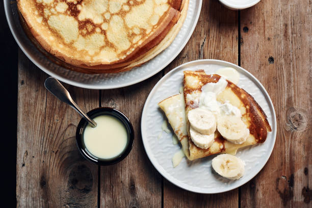 istock Thin pancakes, crepes with bananas and condensed milk. 1293786452