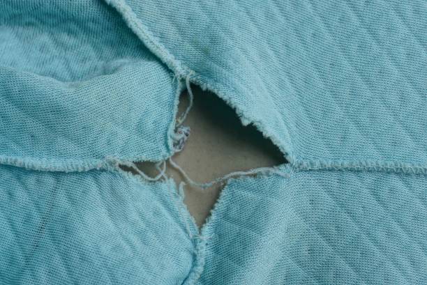 istock clothing with a big gray hole on old  matter 1293786515