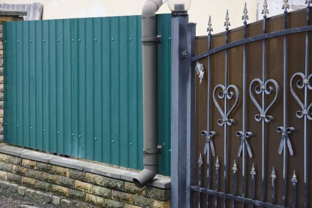 istock long gray metal drainpipe at the green wall 1293786614