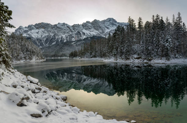 istock Emerald green water of lake Eibsee in winter 1293787367