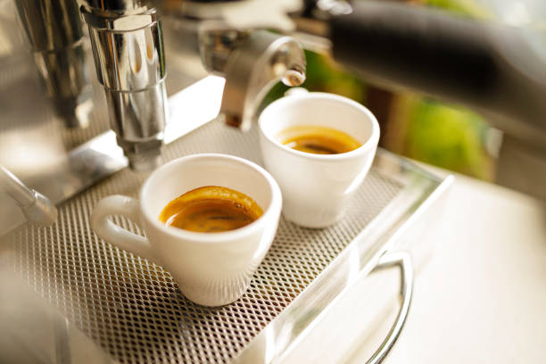 istock two cups of espresso being poured from an espresso machine 1293787421