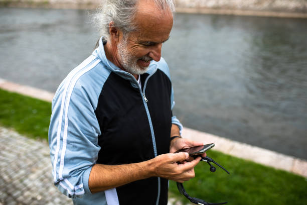 istock A mature man checking his phone while out for a run 1293788461