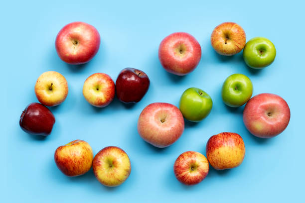 istock Variety of apples on blue background. Top view 1293791064