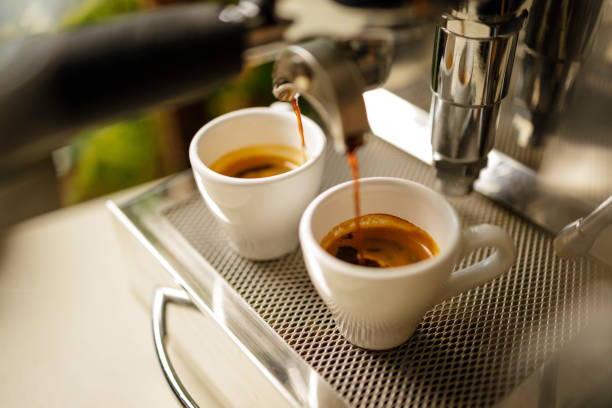 istock two cups of espresso being poured from an espresso machine 1293791996