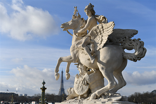Paris, France-12 30 2020:The statue of Mercury riding pegasus at the entrance of the Tuileries garden in Paris, France by sculptor Charles Antoine Coysevox (1640-1720) who was a French sculptor in the Baroque and Style Louis XIV, best known for his sculpture decorating the gardens and Palace of Versailles and his portrait busts.