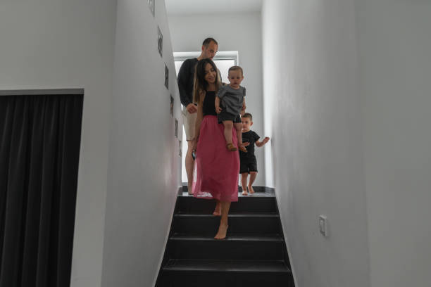 istock Young couple with kids on staircase 1293797669
