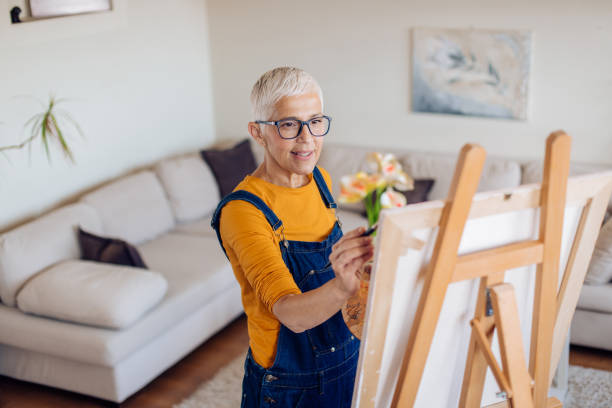 istock Happy senior artist working at home 1293798497