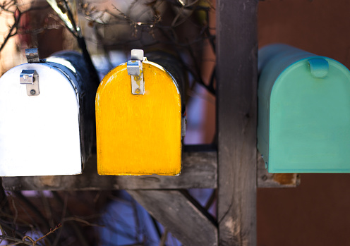 Three Colorful Vintage Rural Mailboxes in a Row