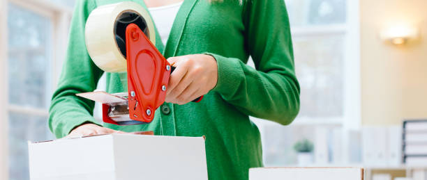 istock Young woman packing boxes to be shipped 1293799819