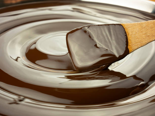 istock melted dark chocolate spiral with wooden ladle, full frame, mixing liquid chocolate 1293801417