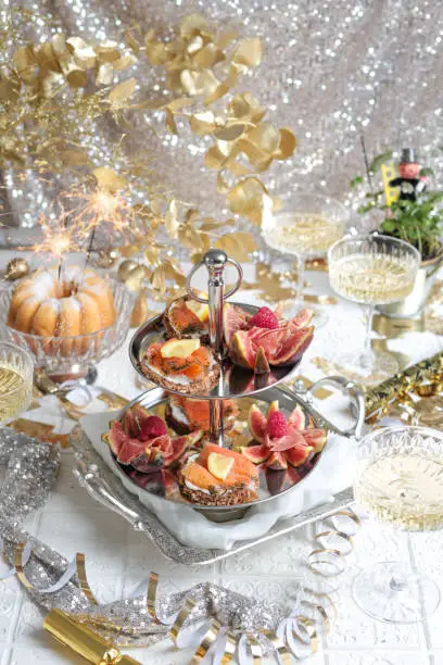 Festive Party Table with Seafood Appetizer Etagere Tower and Champagne for elegant brunch