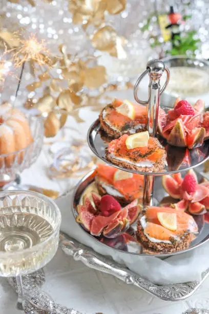 Festive Party Table with Seafood Appetizer Etagere Tower and Champagne for elegant brunch