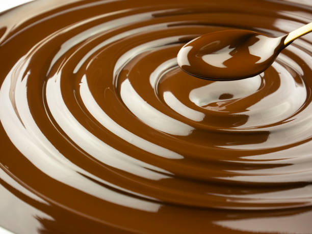istock melted dark chocolate spiral with spoon, high quality pastry background master chocolatier 1293802510