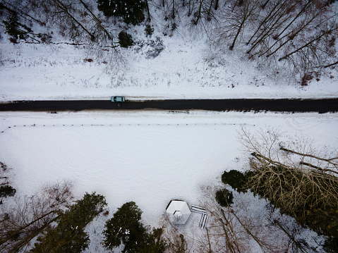 Directly Above a Car on Coutry Road in Winter.