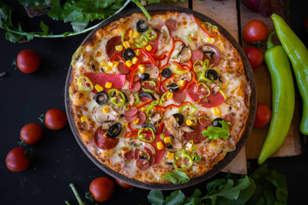istock Mix Pizza With Green Pepper Tomatoes And Arugulas On Black Background 1293807276