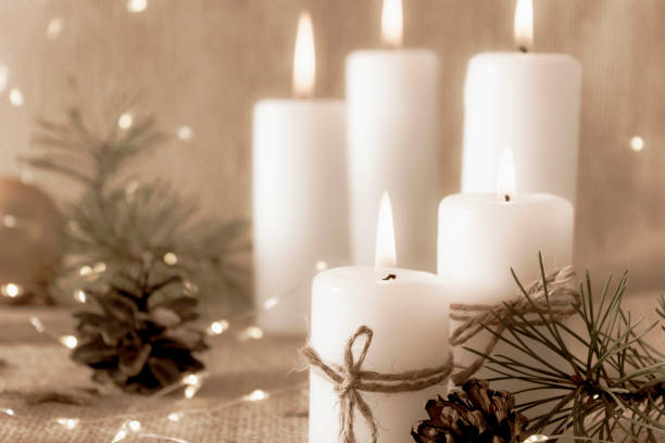 istock Burning candles on a natural beige background. Greeting card. 1293807353