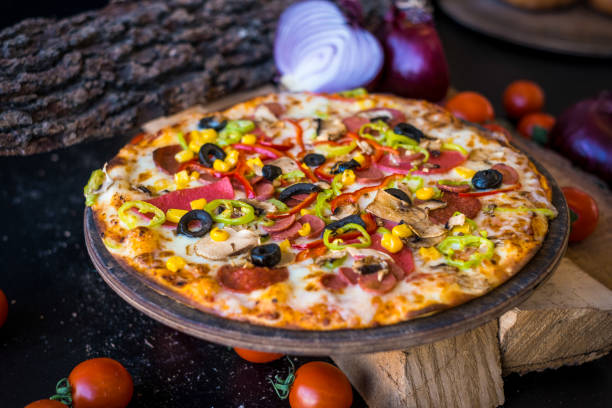 istock Mix pizza with onion and tomatoes on chopped woods. 1293807472