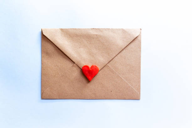 istock love letter in a craft envelope with clay red heart on light blue background. 1293811063