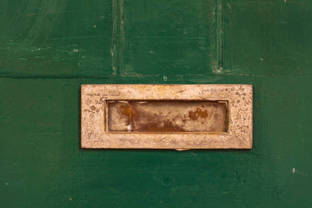 istock Old mail slot in a green door 1293812886