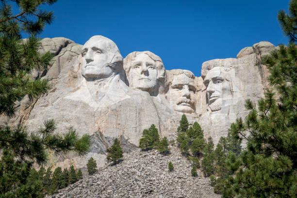The Carved Busts of George Washington, Thomas Jefferson, Theodore Teddy Roosevelt, and Abraham Lincoln at Mount Rushmore National Monument The busts of Presidents George Washington, Thomas Jefferson, Teddy Theodore Roosevelt, and Abraham Lincoln carved Borglum into the Black Hills of South Dakota at Mount Rushmore george washington photos stock pictures, royalty-free photos & images