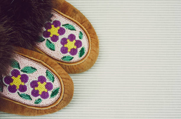 Hand-beaded Moccasins A pair of hand-beaded Moccasin slippers indigenous peoples day stock pictures, royalty-free photos & images
