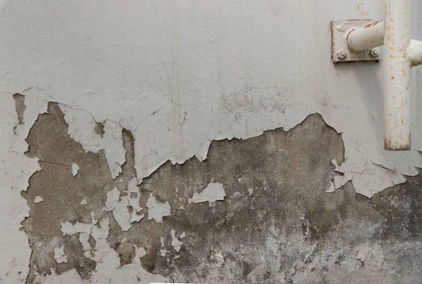 istock Textured surface of old concrete wall with cracks stands. 1293814849