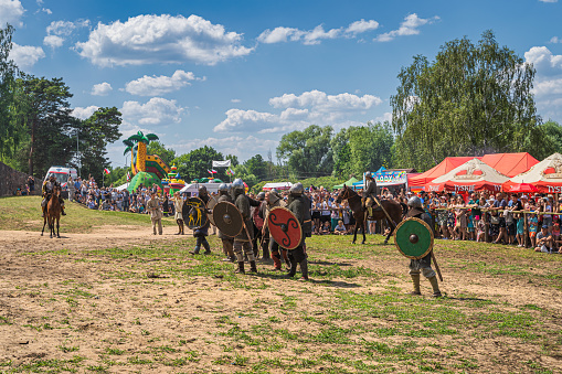 Cedynia, Poland, June 2019 Army of warriors preparing to attack fort with crowd of spectators in background. Historical reenactment of Battle of Cedynia between Poland and Germany, circa 11th century
