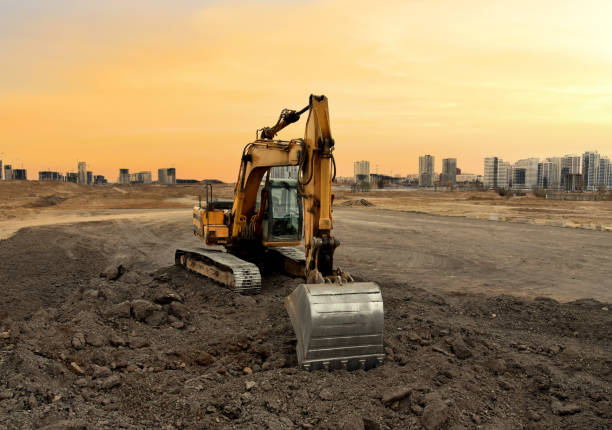 istock Excavator on earthworks at construction site on sunset background 1293818694
