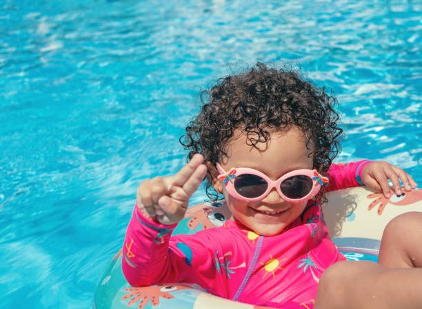 istock Little girl enjoys the pool 1293822016