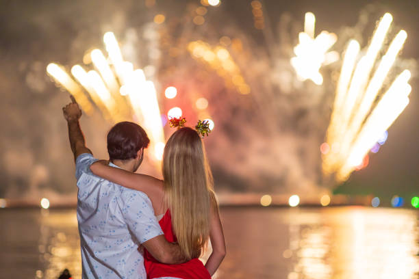 istock Young couple enjoy firework during celebration festival on the beach. 1293822075