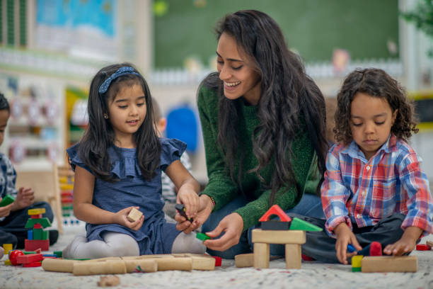 istock Preschool classroom teacher with children 1293822711