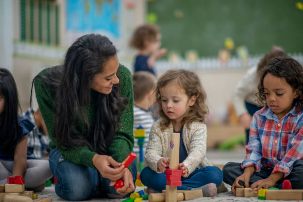 istock Preschool classroom teacher with children 1293822715