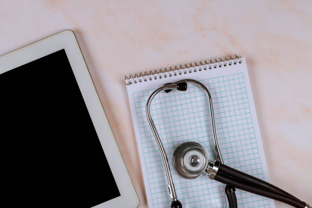 istock Medicine consept white sheet paper with phonendoscope stethoscope, digital tablet on marble background with copy space for text. 1293823572