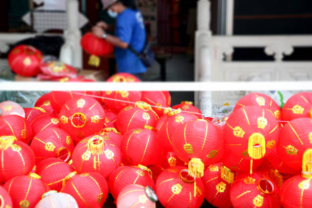 A Myanmar ethnicity worker unboxing to prepare fresh red Chinese lantern for installation in Thean Hou Temple - welcoming Chinese New Year in Kuala Lumpur, Malaysia.