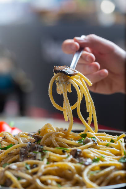 istock Man Eating Italian Spaghetti Pasta With Mushrooms and herbs 1293824620