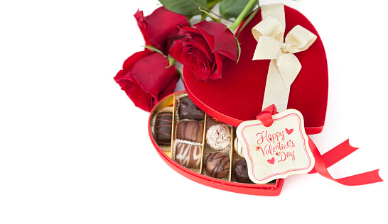 Valentine's Day Heart Shaped Box of Chocolates and Red Roses on white