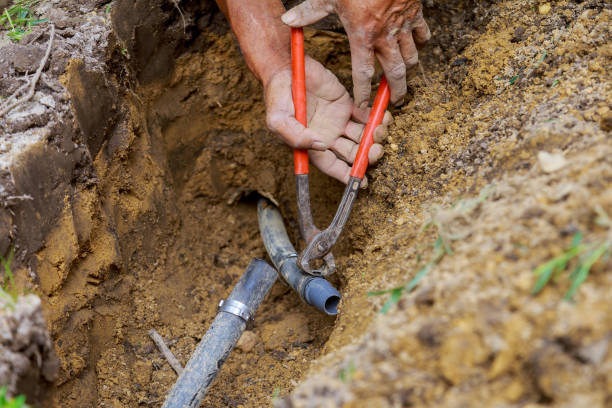istock Man working with pipes in ground while Installing a New underground sprinkler system 1293832796