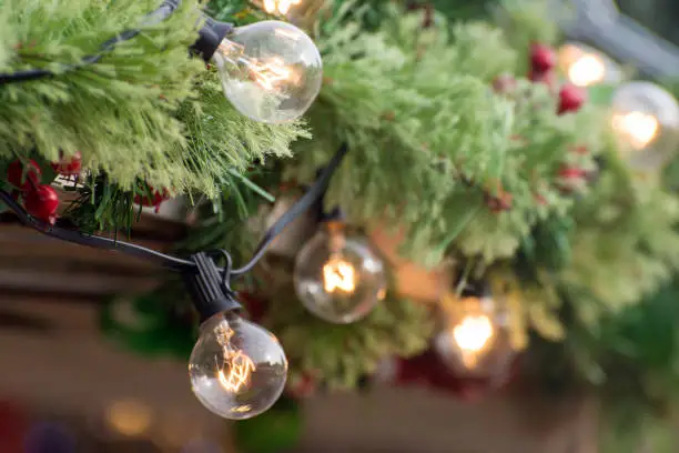 Photo of Holidays garlands and lights. Soft background and beautiful bokeh. Defocused and noise photo.