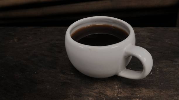 istock A cup of black coffee in dim light 1293838032