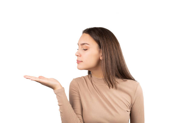 istock pretty young girl looking ot her opened hand 1293841076