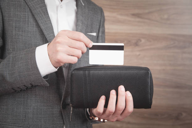 istock Man holding credit card and wallet. 1293843533