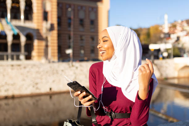 istock Happy Middle Eastern woman using a smart phone 1293844283