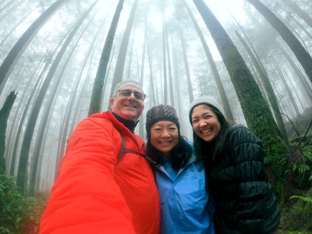 istock Multi-Ethnic Family Taking Selfie in Misty Forest While Hiking 1293847780