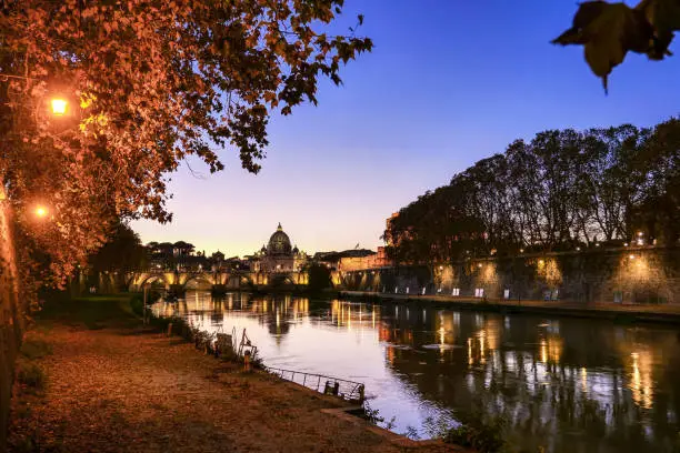 Photo of The sunset light envelops the banks of the Tiber river in the heart of Rome creating a pictorial mood