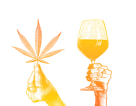 Hands holding wineglass and hemp leaves