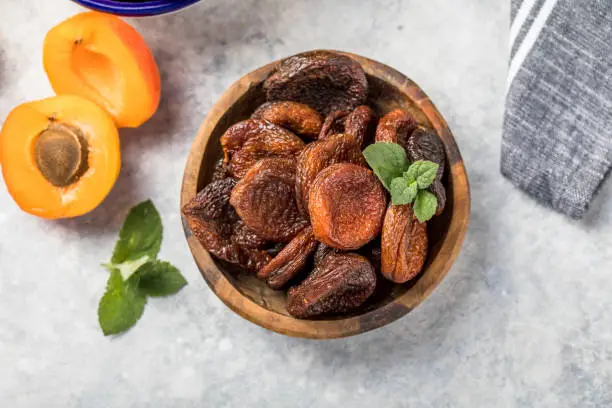 Photo of Dried apricots are popular in cooking, sweet dried fruit, healthy food, compote making.