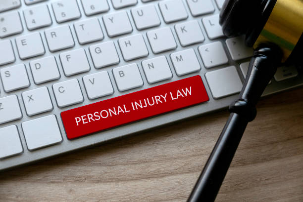 Personal Injury Law Selective focus of gavel and computer keyboard with red key written with Personal Injury Law on a wooden background. gavel keyboard stock pictures, royalty-free photos & images